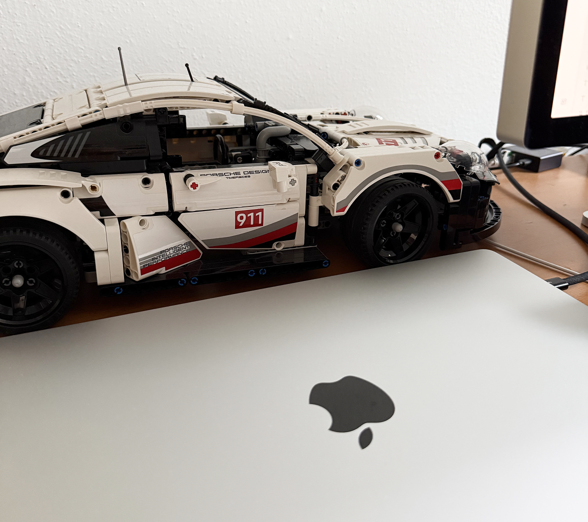 MacBook and model car on my desk
